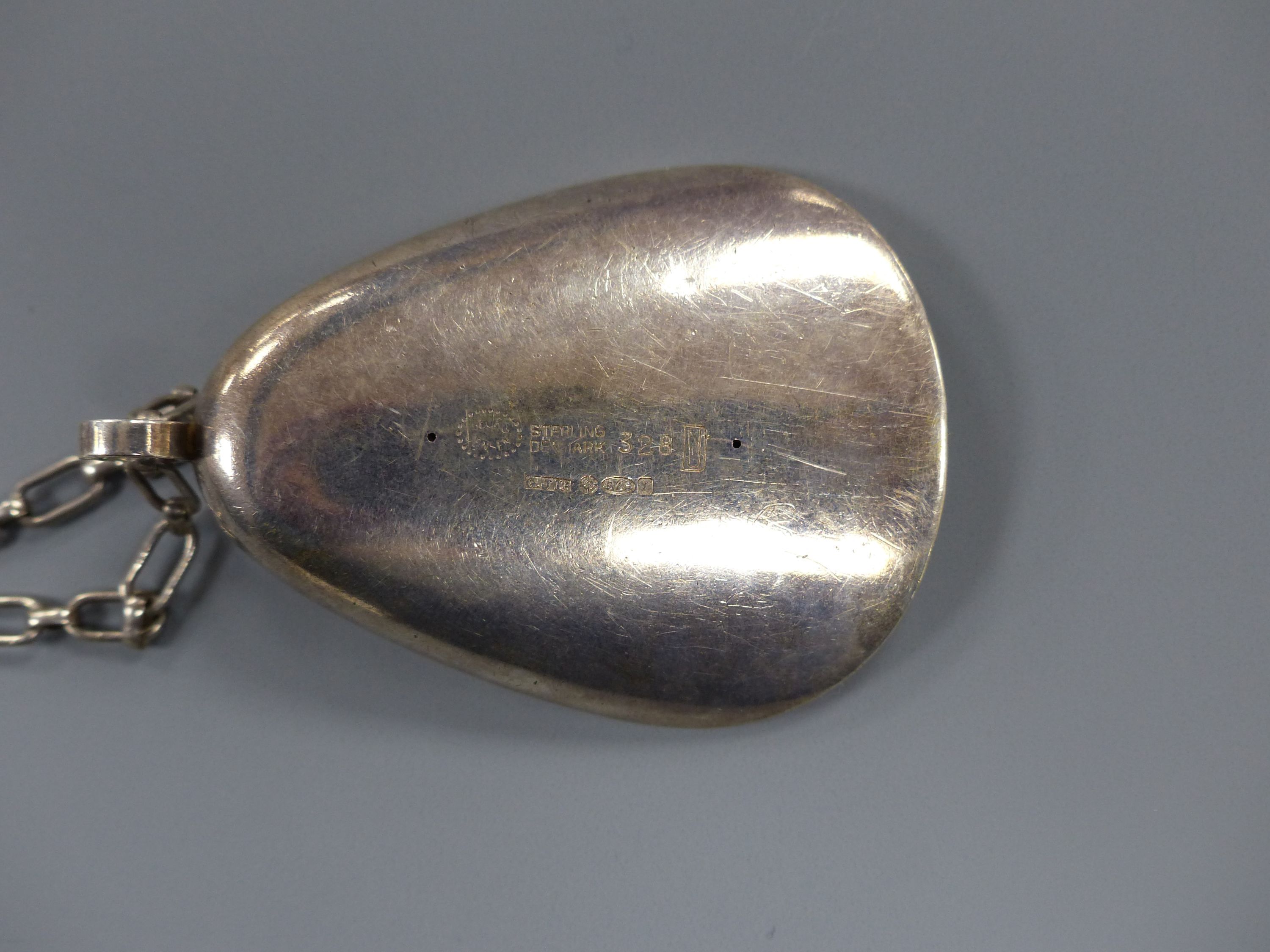 A 1960's Nanna & Jorgen Ditzel for Georg Jensen sterling oyster shell pendant, 60mm, design no 328, on a white metal chain, 84cm